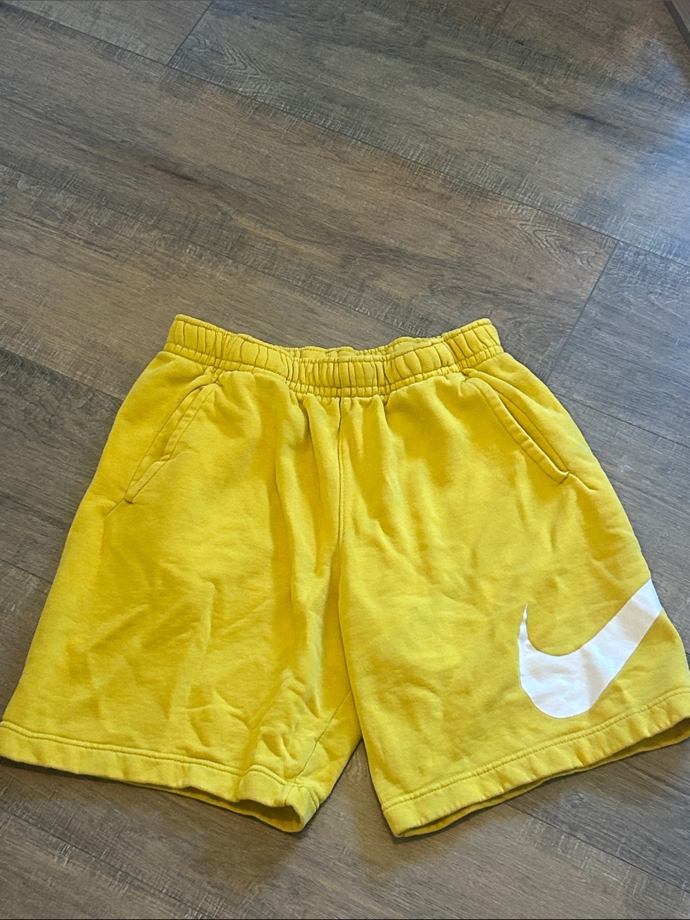 Nike Yellow Athletic Shorts with White Swoosh